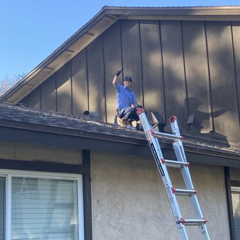 Roman high atop the roof performing inspection of my drain line