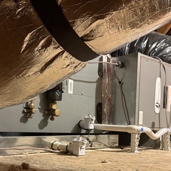 Heat pump in attic with platform and new duct work.