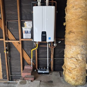 AFTER. New Navien tankless water heater with smaller footprint. Also NEW pressure regulator valve on the left.