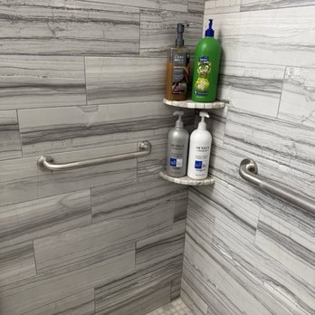 Grab bars solidly attached to the shower walls.