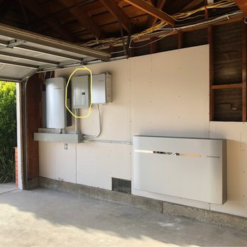 The entire combiner, smart switch, critical load panel and 10kW bagger installed cleanly in our garage.